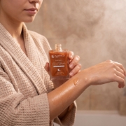 Mastic Spa Shimmering Dry Oil 100ml bottle with antioxidant Vitamin E and mastic gum on marble.