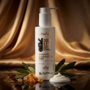 Mastic Spa Donkey Milk and Mastic Oil Shampoo & Conditioner on a dark reflective surface with a luxurious golden draped fabric background, featuring olive leaves and mastic resin.