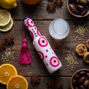 Greek Ouzo 50ml Mini Bottle Pink with Aegean Blue Evil Eye Charm on a clean ecommerce background